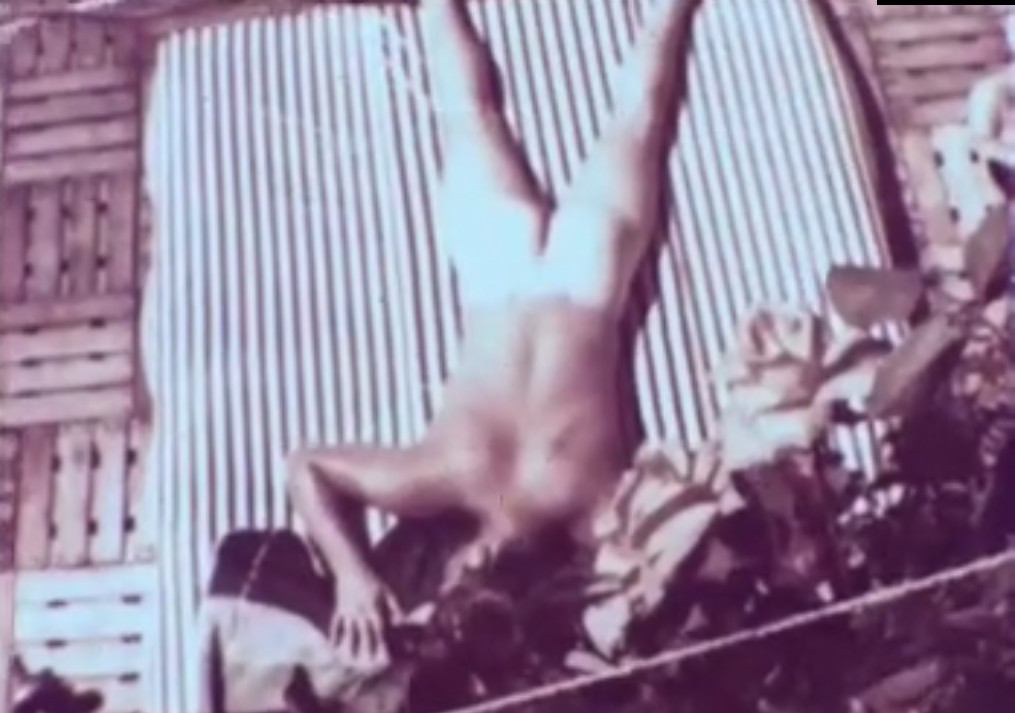 Mike Pohl sunbathing naked on a rooftop.

